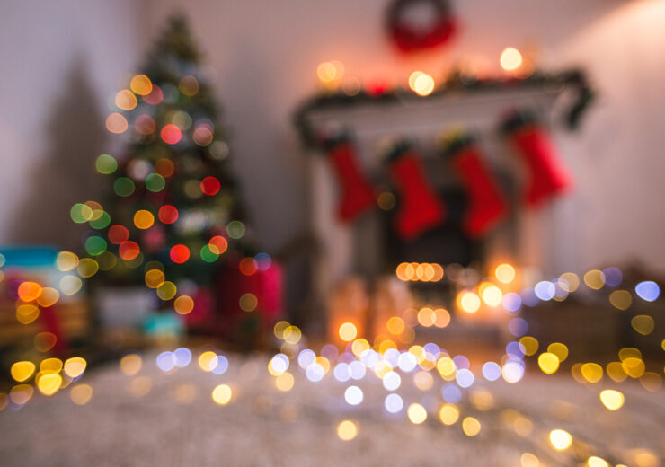 Defocused of christmas tree lights and fireplace