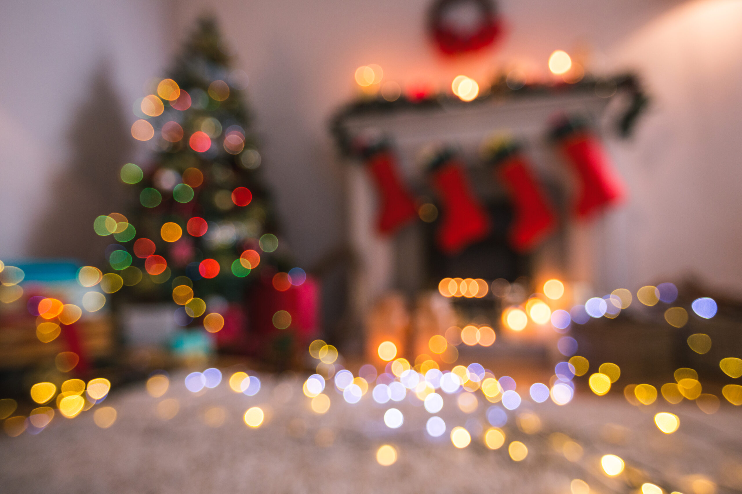 Defocused of christmas tree lights and fireplace