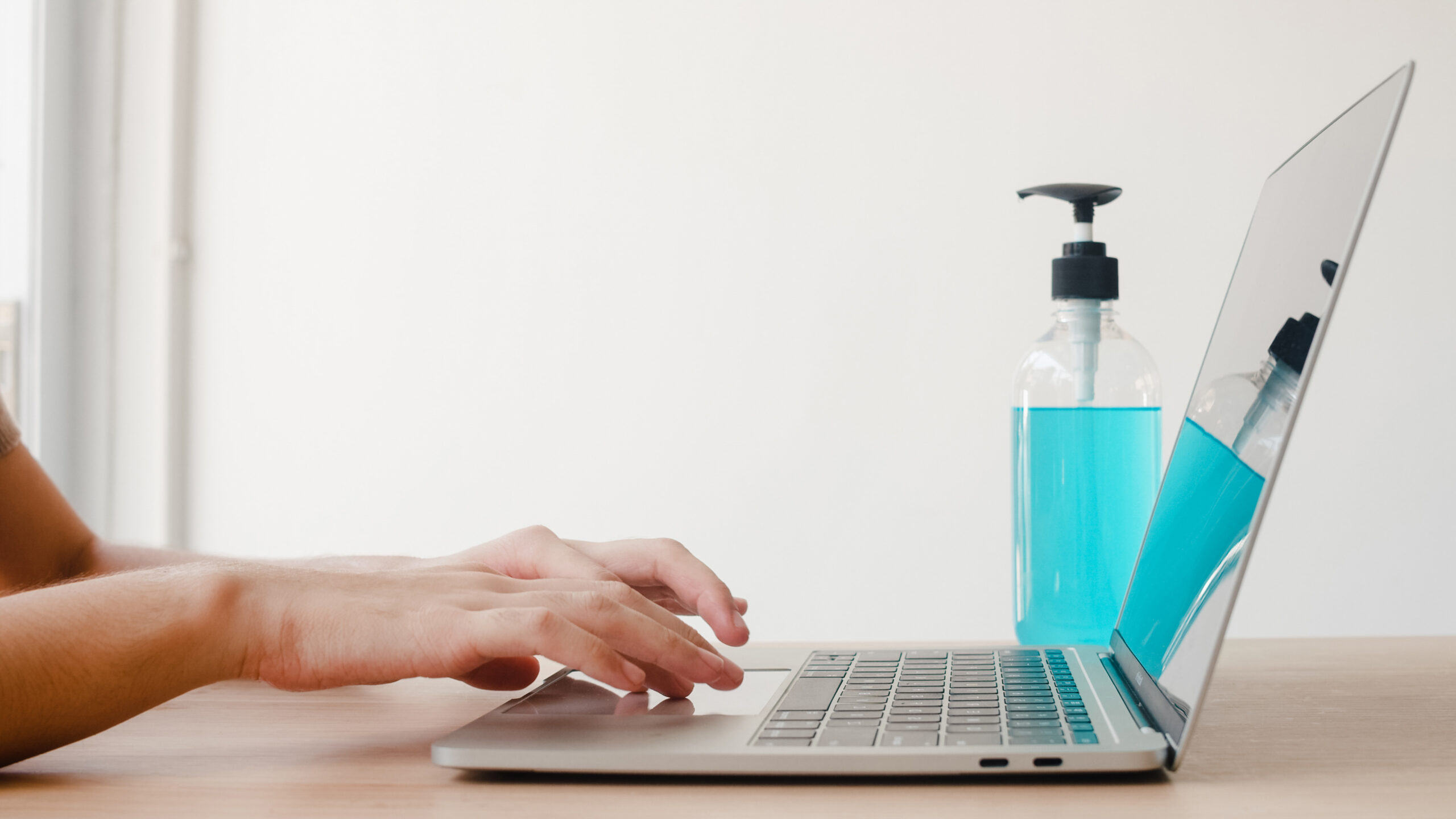 Asian woman using alcohol gel sanitizer wash hand before work on